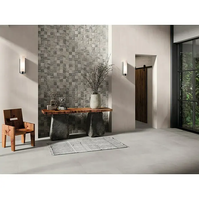 Verblendstein Sakura Gris - 60 x 20 cm, Steinoptik - Einladender Eingangsbereich mit quadratischen Wandfliesen, rustikalem Holztisch und modernem Holzstuhl, der eine warme und stilvolle Atmosphäre schafft.