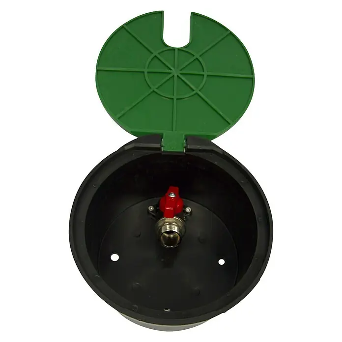 Arqueta redonda con tapa - Dimensión conexión: ¾″ - Una caja de válvulas negra y redonda con una tapa verde abierta y un grifo rojo en el interior.