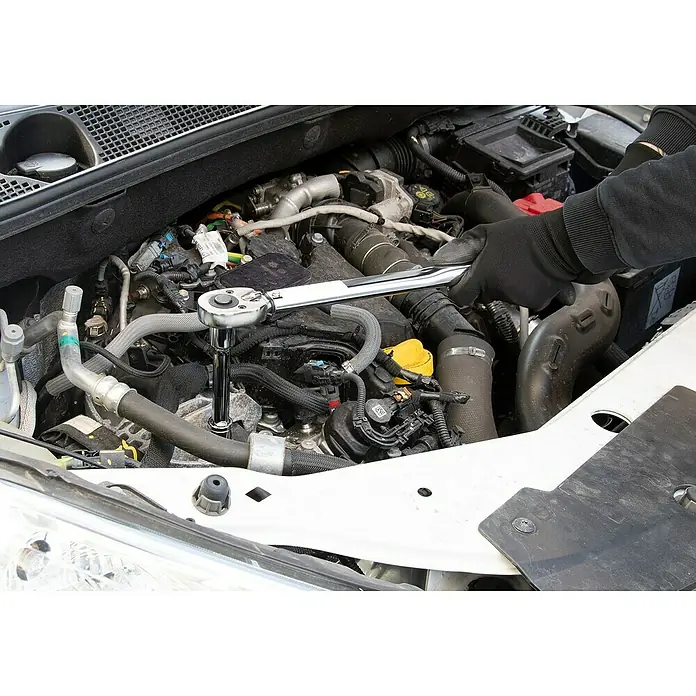 Alpha Tools Drehmomentschlüssel - 28 Nm - 210 Nm, ½″, 5 -tlg. - Das Bild zeigt eine Person, die mit einem Schraubenschlüssel an einem Automotor arbeitet. Der Fokus liegt auf dem Werkzeug und den Motorraumdetails.