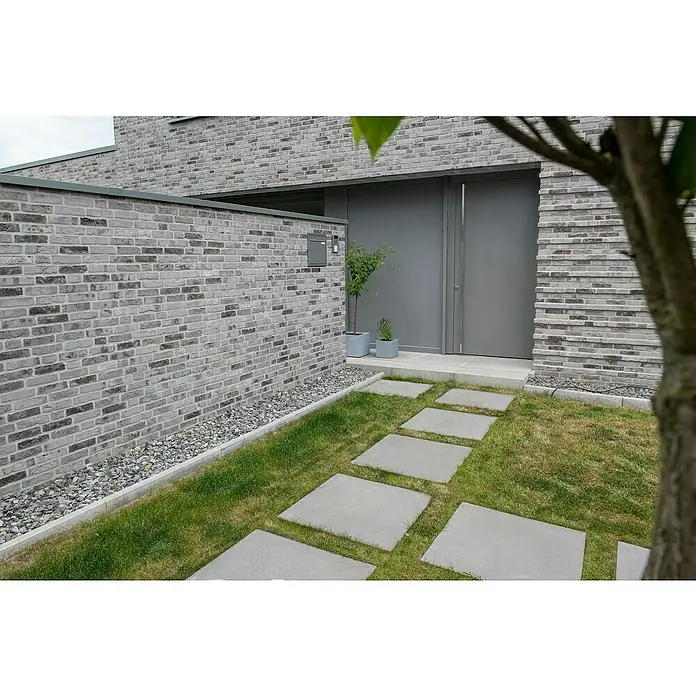 Diephaus Gehwegplatte - 40 x 40 x 4 cm, Grau, Beton - Ein moderner Eingangsbereich mit grauem Backsteinmauerwerk, geradliniger Tür und einem Weg aus Betonplatten durch grünen Rasen. Der Garten ist minimalistisch gestaltet.