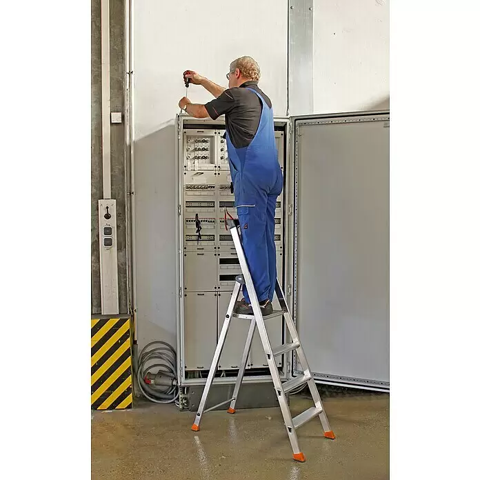 Krause Monto Stehleiter Solido - Anzahl Tritte: 4 Stk., Arbeitshöhe: 2,85 m, Aluminium - Silberne Trittleiter mit orangen Füßen, ein Mann in blauer Arbeitskleidung arbeitet an einem Schaltschrank.