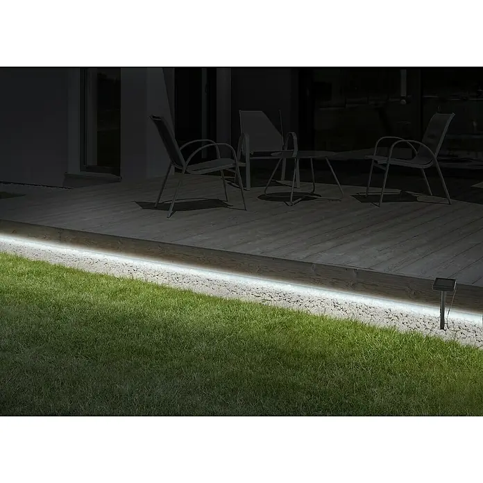 Globo Tira de luces LED - Largo: 18 m, Color de luz: Blanco neutro, 25,92 W, 864 lm - Tira de luces LED ilumina un patio con muebles de jardín y césped. La iluminación crea un ambiente moderno y acogedor en la zona exterior.