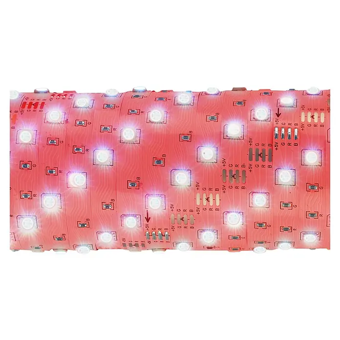 Briloner Tira LED inteligente RGB + USB - 7 W, Multicolor, Largo: 5 m, RGB - Primer plano de una tira LED flexible con una placa de circuito roja, que presenta puntos de conexión para +5V, verde, rojo y azul.
