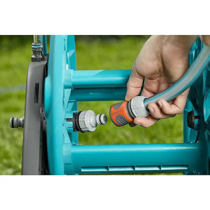 Gardena Schlauchwagen CleverRoll M - Kunststoff/Metall, Schlauchkapazität: 60 m, 13 mm (½″) - Nahaufnahme der Gardena Schlauchkupplung beim Verbinden mit einer Schlauchtrommel, ideal für Gartenbewässerung.