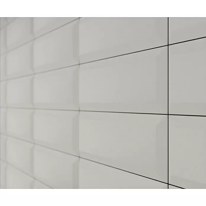 Modern Style Wandfliese Metro Biselado - 9,8 x 29,8 cm, Weiß, Matt - Weiße, rechteckige Fliesen mit dunklen Fugen, schräg betrachtet, mit abgeschrägter Kante.