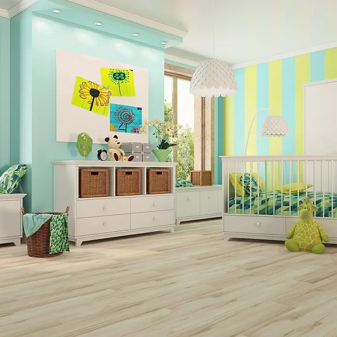 LOGOCLIC Rodapié Roble Monik - 220 cm x 15 mm x 80 mm, MDF - Vista de una habitación infantil con cómoda blanca, cuna y juguetes sobre un piso de madera clara. Decorado en verde y azul.