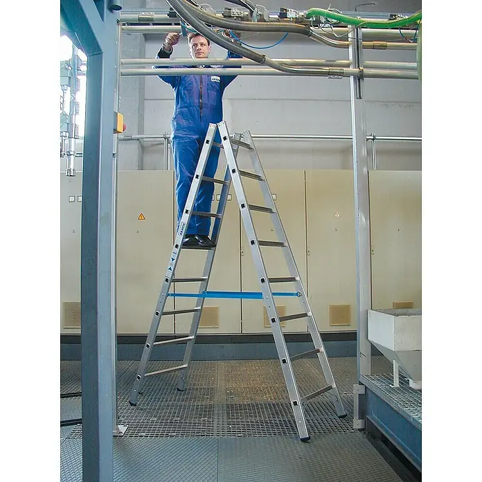 Krause Stabilo Doppelleiter - Anzahl Tritte: 16 Stk., Arbeitshöhe: 3,55 m, Aluminium - Mann auf einer KRAUSE Doppelstufen-Stehleiter bei Wartungsarbeiten. Robuste Aluminiumleiter für sicheren Stand in Industrie und Handwerk.