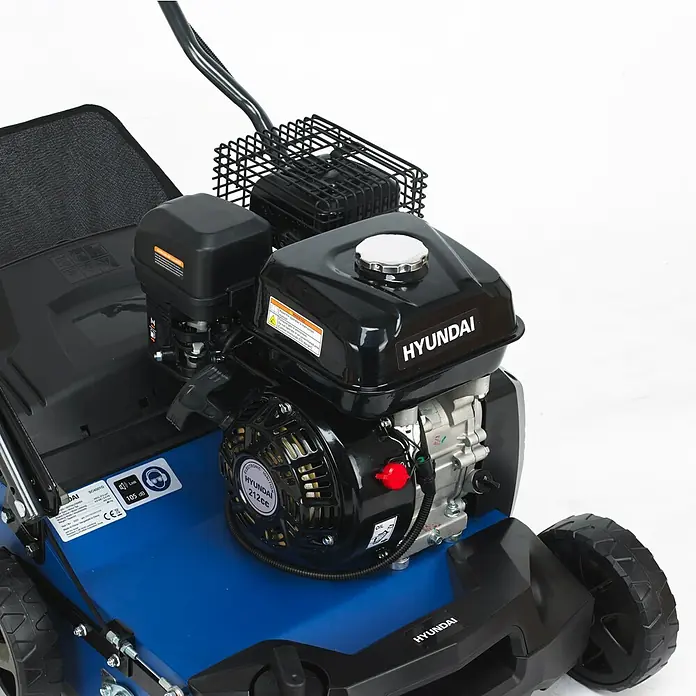 Hyundai Benzin-Vertikutierer-Lüfter SC4001G - 4 kW, Arbeitsbreite: 40 cm - Nahaufnahme eines blauen Hyundai Rasenmähers mit schwarzem Motor.