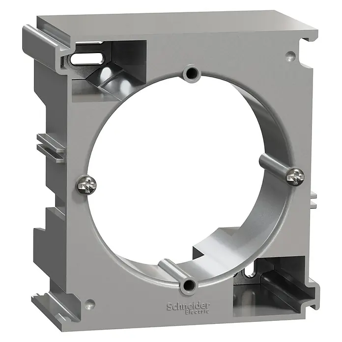 Schneider Electric Sedna Design & Elements Caja de superficie - 4,3 x 7,8 x 8,4 cm, Colocar, Aluminio - Primer plano de un dispositivo de montaje de Schneider Electric que muestra una caja metálica con una abertura circular en el centro.