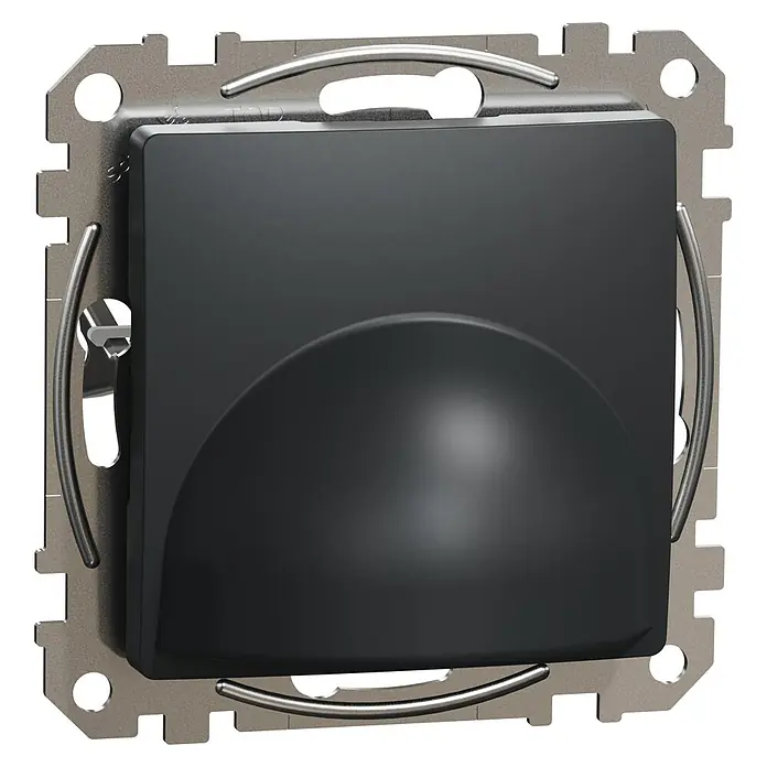 Schneider Electric Sedna Design & Elements Tapa ciega salida de cables - Antracita, Satinado, Plástico, Montaje en superficie - Primer plano de un detector de movimiento negro con un marco plateado y formas redondeadas, montado sobre una superficie negra.