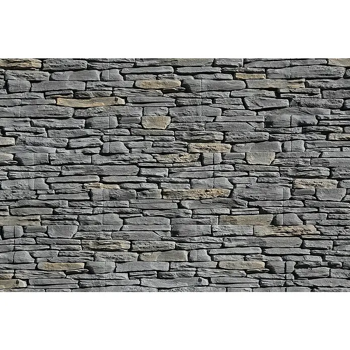 Stegu Verblendstein Porto - 11 x 54 cm, Graphit, Steinoptik - Eine Nahaufnahme einer grauen Steinwand mit horizontal angeordneten Steinen in verschiedenen Größen.