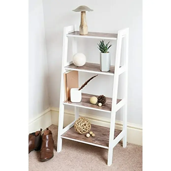 D-c-fix Lámina para ventana efecto madera rústico - 45 x 200 cm - Una estantería de escalera blanca y elegante con cuatro estantes decorados con aspecto de madera, adornada con varios objetos decorativos, junto a unas botas marrones.