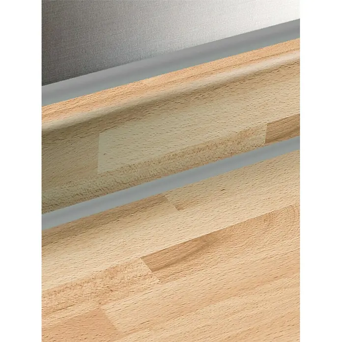 Resopal Basic Encimera de cocina al corte - Beech Board, Espesor: 3,8 cm, Ancho: 90 cm - Primer plano de un mostrador de madera clara con detalles plateados que resaltan la veta y la textura de la madera.
