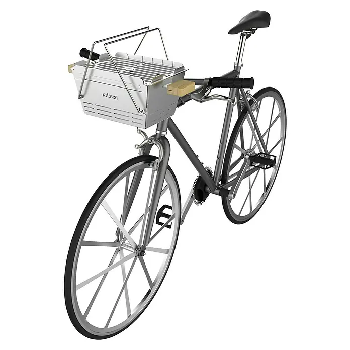 Knister Fahrradhalterung - L x B x H: 13 x 13 x 10 cm, Passend für: Knister Grill Modelle / Handelsübliche Fahrradlenker - Produktansicht eines Fahrrads mit einem am Lenker befestigten Grill, ideal für Picknicks im Freien.