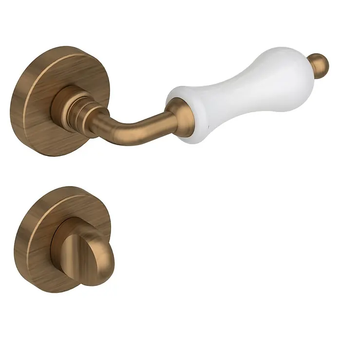 Diamond Doors Classic Zimmertürgarnitur WC Columbus - Bronze, Stärke Tür: 40 mm - 45 mm, Schlitzkopf/Olive - Nahaufnahme eines Türgriffs mit weißem Griff und einer bronzefarbenen Rosette und Drehknopf, der eine elegante Note verleiht.