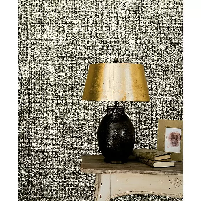 Marburg Vintage Deluxe Vliestapete Retro - Gold-Braun, Uni, 10,05 x 0,53 m - Gewebte Tapete in Hellgrau- und Beigetönen, an einer Wand hinter einer Lampe und einem Tisch.