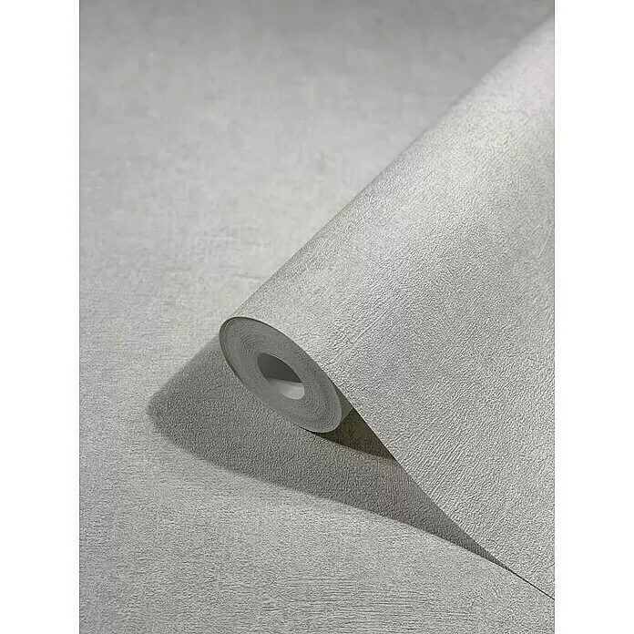 Marburg Vintage Deluxe Vliestapete - Greige, Uni, 10,05 x 0,53 m - Teilweise abgerollte Rolle grauer, texturierter Tapete mit schimmernder Oberfläche.