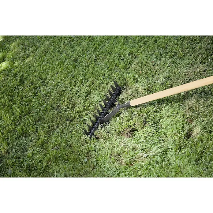 Gardol Rasenlüfter - Arbeitsbreite: 38 cm, Langstiel - Bild einer Gartenkralle mit Holzgriff, die im Gras liegt. Ideal für die Gartenarbeit und Bodenbearbeitung.