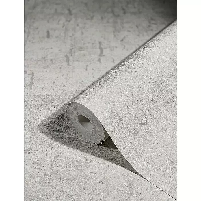 Marburg Natural Opulence Vliestapete - Weiß I, Betonoptik, 10,05 x 0,7 m - Eine Rolle hellgraue Tapete mit strukturierter, Beton-ähnlicher Optik, teilweise abgerollt, um ihr Design zu zeigen.