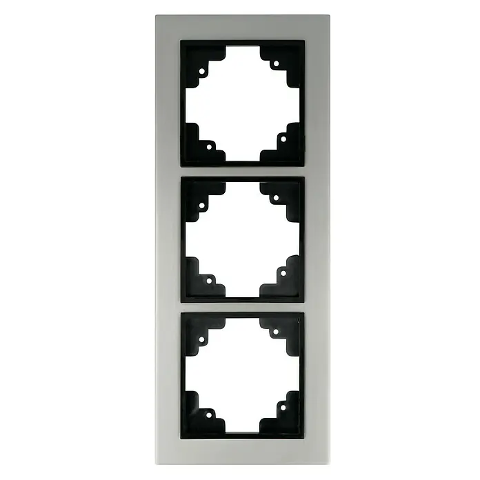 Voltomat FERA Abdeckrahmen Variante A - Edelstahl, 3-fach, Edelstahl - Eine längliche, weiße Platte mit drei schwarzen, quadratischen Aussparungen mit dekorativen Ecken für Schalter oder Steckdosen.