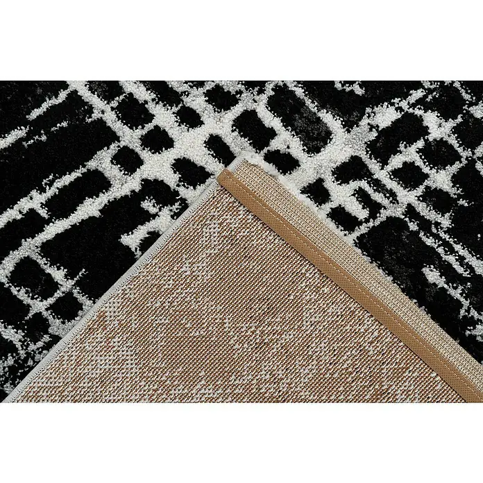 Kurzflorteppich Louvre - Silber, 230 x 160 cm, 100% Polypropylen (Flor) - Detailansicht eines modernen Teppichs mit abstraktem Muster in Schwarz, Weiß und Braun, der Textur und Design hervorhebt.