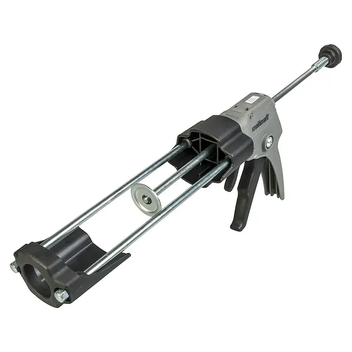 Wolfcraft Kartuschenpresse MG 611 - Geeignet für: Acryl - Eine Wolfcraft Auspresspistole für Kartuschen. Das Werkzeug hat einen grauen Griff und eine schwarze Halterung für die Kartusche.