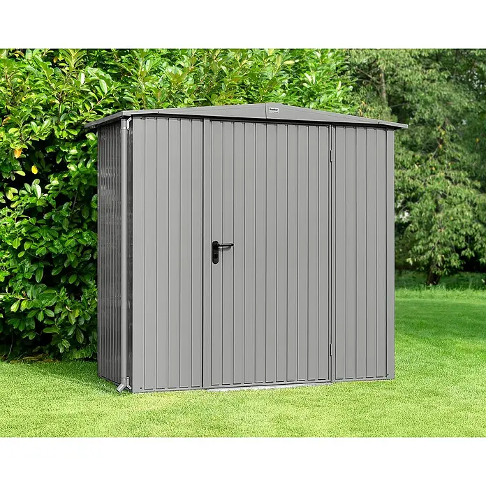 EcoStar Gerätehaus Trend-S Typ 1 - Außenbreite inkl. Dachüberstand: 258,8 cm, Außentiefe inkl. Dachüberstand: 121,3 cm, Grau, Einzeltür - Eine graue, rechteckige Gartenhütte aus Metall mit einer Tür und einem abschüssigen Dach, umgeben von Grün.