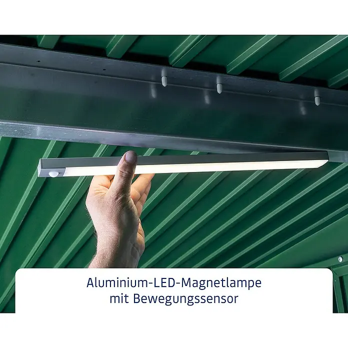 EcoStar LED-Bewegungsmelder - Passend für: EcoStar Gerätehäuser - Aluminium-LED-Magnetlampe mit Bewegungssensor. Die Lampe ist an einer Metalloberfläche befestigt und wird von einer Hand gehalten.