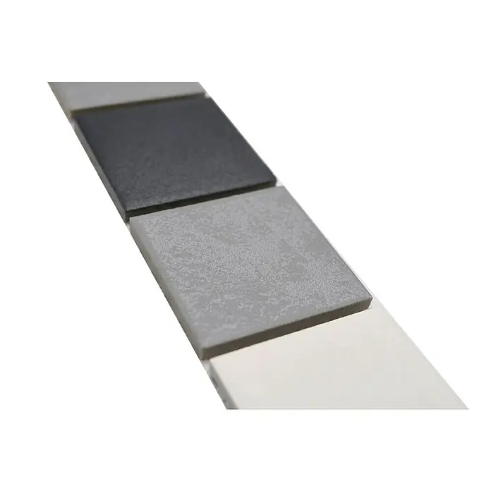 Fliesenbordüre Quadrat - 4,8 x 30 cm, Mix Grau, Matt - Nahaufnahme von quadratischen Fliesenmustern in Grau-, Schwarz- und Weißtönen, die eine minimalistische und moderne Ästhetik zeigen.