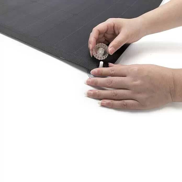 EcoFlow Saugnapf - Farblos, 8 Stk., Höhe: 3 cm, Durchmesser: 4,5 mm - Hände befestigen einen durchsichtigen Kunststoffknopf mit einem Saugnapf an einer schwarzen strukturierten Matte.