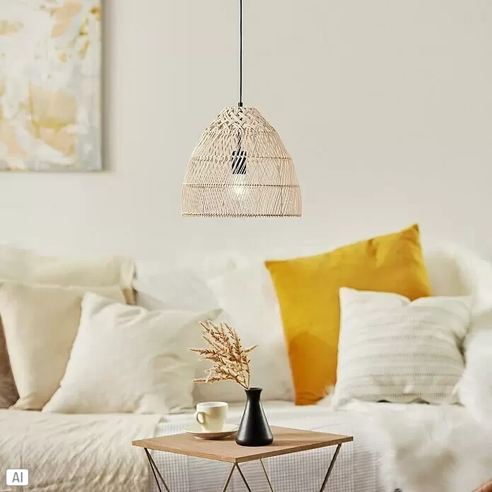 Brilliant Pendelleuchte Minster - 25 W, Schwarz, E27 - Hellbraune Hängeleuchte aus Rattan beleuchtet ein gemütliches Wohnzimmer mit Sofa und Kissen.