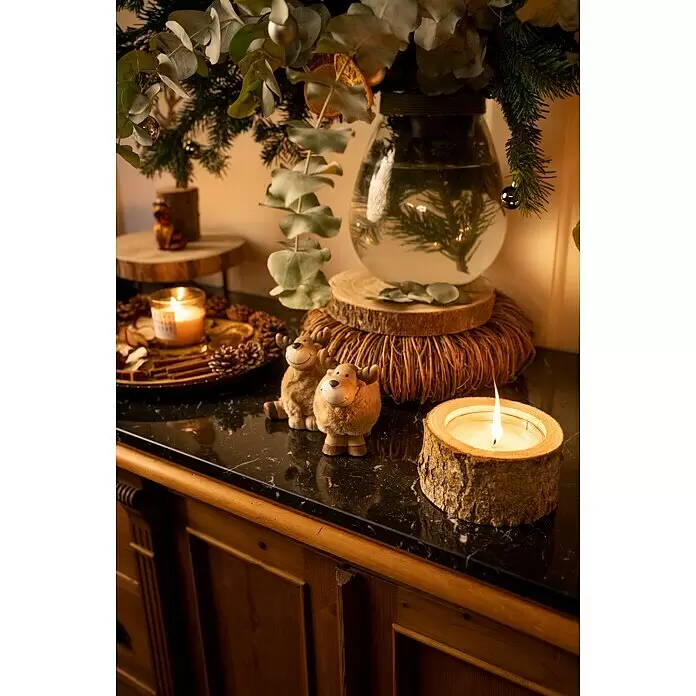 Dekofigur Elch mit Fell - L x B x H: 10 x 7,5 x 14 cm, Polyester - Festliche Weihnachtsdekoration auf dunkler Marmorplatte, mit Kerze in Holzhalter, zwei flauschigen Rentieren und Vase mit Eukalyptus und Kiefer.