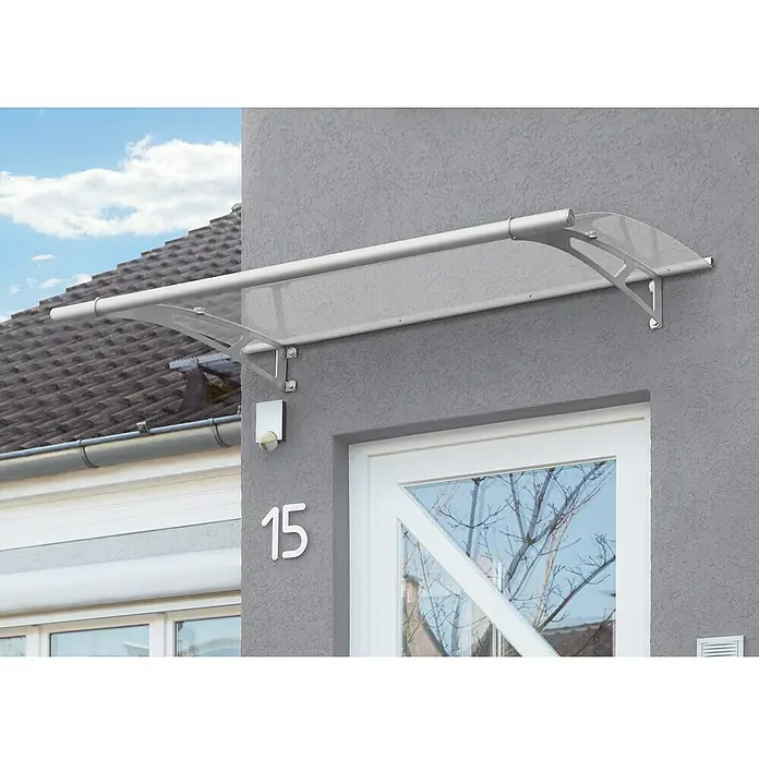 Gutta Pultvordach PT/L - 150 x 95 x 17 cm, Edelstahl, Farbe Dach: Klar - Graue Fassade mit einem Vordach aus transparentem Kunststoff und einer weißen Tür. Das moderne Design schützt den Eingangsbereich.