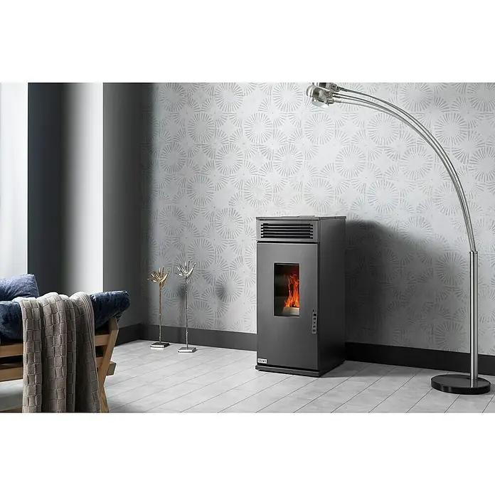 Hidroestufa de pellets Leonora Hidro 24 - 24 kW, Volumen de calefacción: 220 m³, Negro - Una estufa de pellets gris moderna con llamas visibles, elegantemente complementada por una lámpara de arco y elementos decorativos en la habitación.