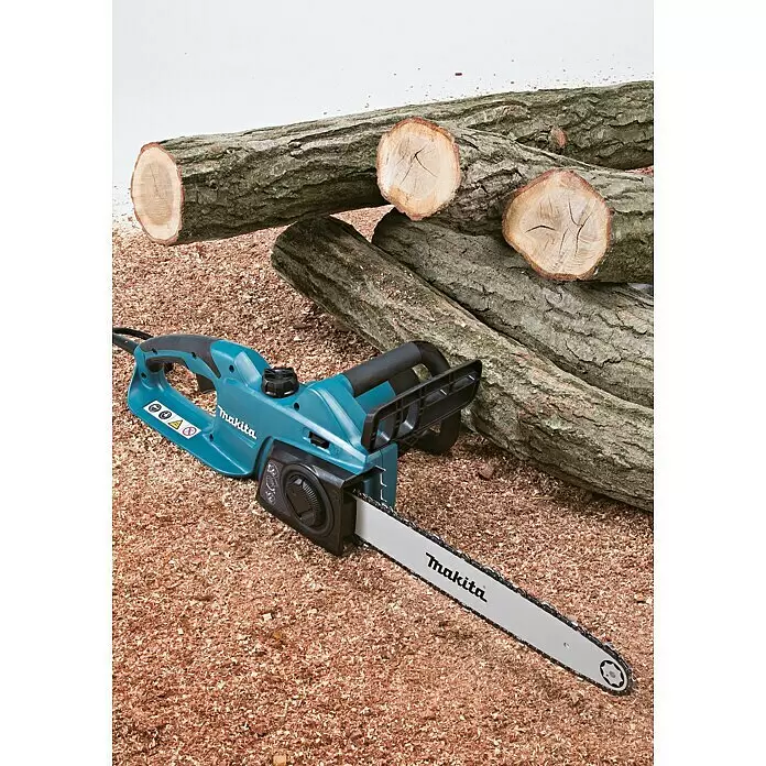 Makita Motosierra eléctrica UC4041A - 1.800 W, Longitud de la cuchilla: 40 cm - Motosierra Makita turquesa y negra sobre aserrín junto a troncos cortados, lista para trabajar la madera.