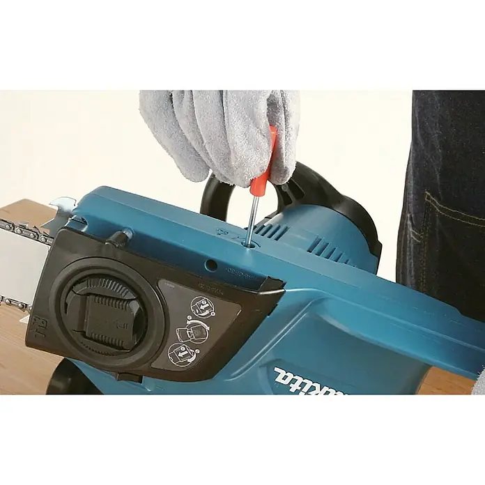 Makita Elektro-Kettensäge UC4041A - 1.800 W, Schwertlänge: 40 cm - Detailaufnahme einer Makita Akku-Kettensäge, die mit einem Schraubenzieher von einer Hand mit Handschuh bedient wird.