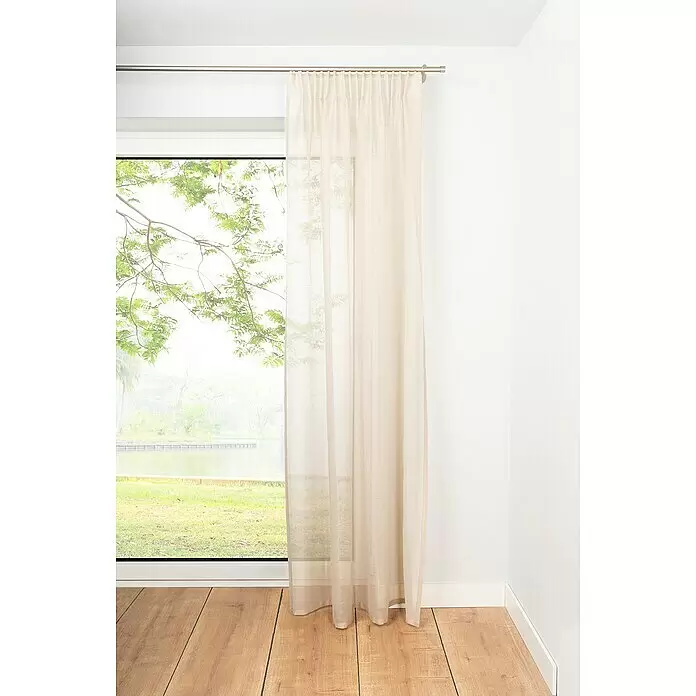 Schlaufenschal Soft - B x H: 135 x 245 cm, 100 % Polyester, Sand - Ein leichter, heller beiger Vorhang hängt elegant an einer silbernen Stange und lässt sanftes Licht durch ein Fenster mit grüner Landschaft.