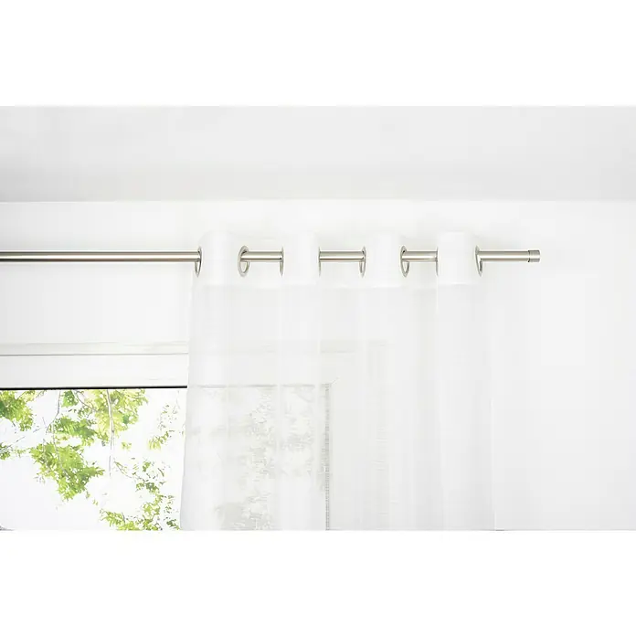 Ösenschal Soft - B x H: 135 x 300 cm, 100 % Polyester, Weiß - Eine Nahaufnahme einer weißen Gardine mit silbernen Ösen, die an einer Stange vor einem Fenster hängt, das Tageslicht hereinlässt.