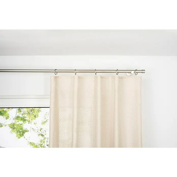Schlaufenschal Dot - B x H: 135 x 245 cm, 100 % Polyester, Sand - Helle Gardine hängt an einer silbernen Gardinenstange mit Ringen, teilweise vor einem Fenster. Die Vorhänge sind blickdicht und dekorativ.
