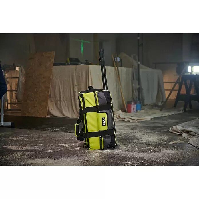 Ryobi Werkzeugtasche RSSLTB2 - Polyester - Gelbe und graue Ryobi Rollwerkzeugtasche steht auf staubigem Baustellenboden.