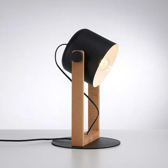 Just Light Cup Lámpara de sobremesa redonda - 60 W, Ø x Al: 23 x 41 cm, Negro/Madera, E27 - Primer plano de una lámpara de escritorio moderna con pantalla negra y base de madera, emitiendo una luz cálida.