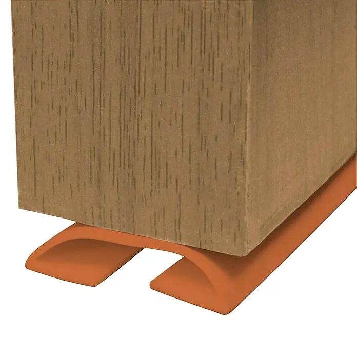 Junta para puerta Antipinzamiento - Marrón, Largo: 1 m - Primer plano de una pata de mueble de madera con un protector de piso naranja, diseñado para evitar arañazos y daños.