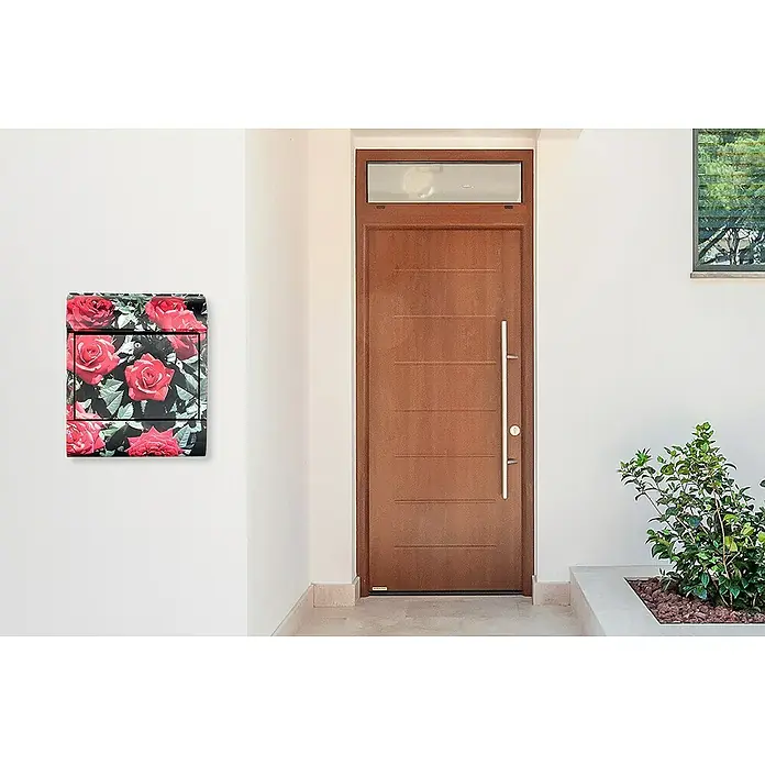 Wandbriefkasten - L x B x H: 12 x 38 x 45 cm, Stahl, Zeitungsfach, Rote Rosen - Ein Rosen-Wandbriefkasten ist auf der weißen Wand zu sehen, neben einer modernen Holztür und einer Grünpflanze.