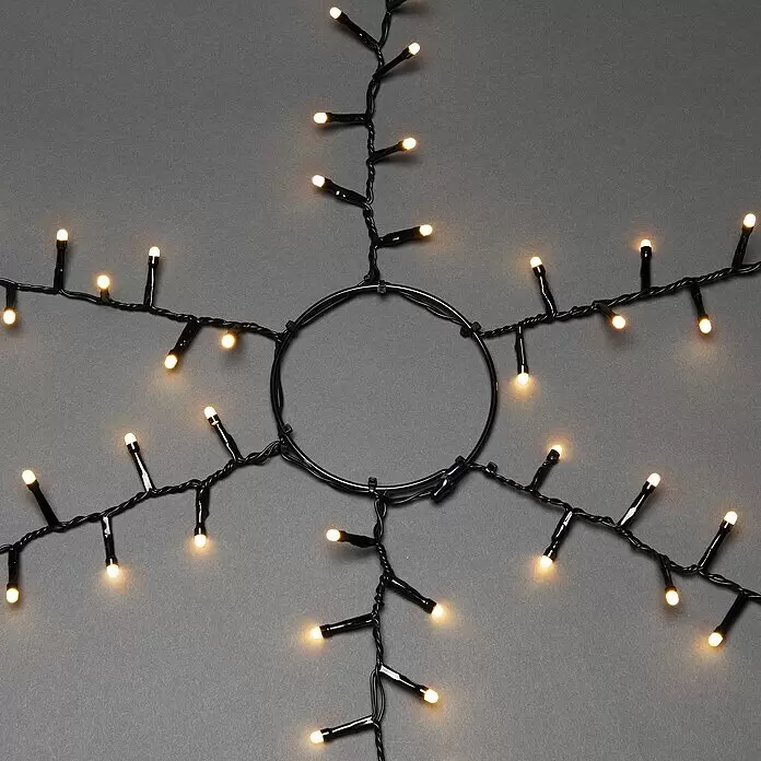 Konstsmide Baummantel - Außen, 2,4 m, 6 Stränge à 110 gefrostete bernsteinfarbene LEDs, Anzahl Leuchtmittel: 660 Stk., Lichtfarbe: Bernstein - Schwarze LED-Lichterkette mit warmweißen Birnen, sternförmig angeordnet zur Dekoration.