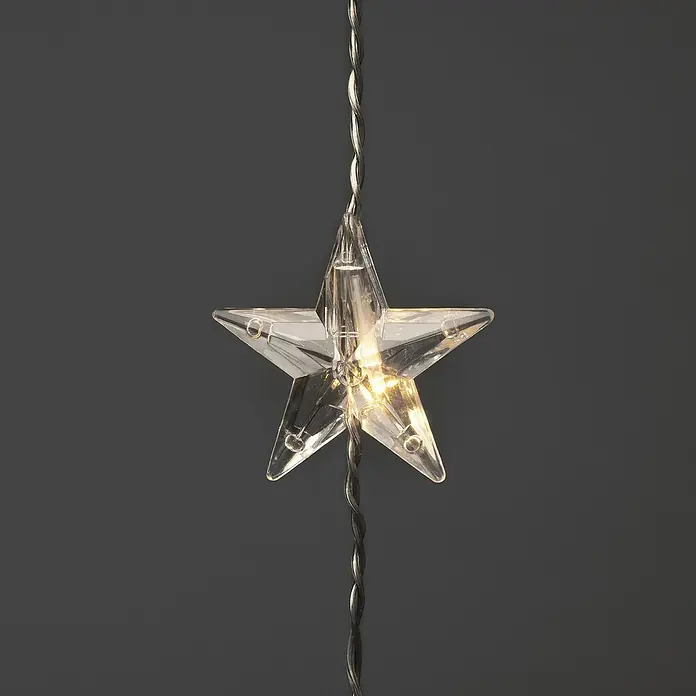 Konstsmide LED-Lichtervorhang Sterne - B x H: 140 x 120 cm, Innen, Kunststoff, Warmweiß - Nahaufnahme eines klaren Sternlichts an einem silbernen Draht, das ein warmes, einladendes Licht ausstrahlt.