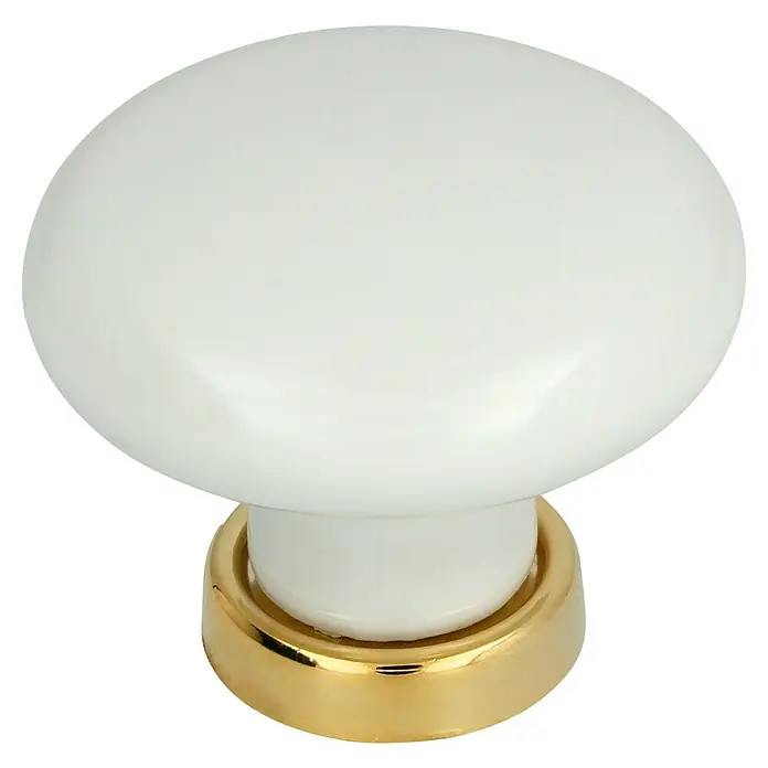 Häfele Pomo para muebles - Tipo de tirador del mueble: Botón, Ø x Al: 37 x 21 mm, Porcelana - Primer plano de un tirador de armario blanco con base dorada sobre un fondo negro.