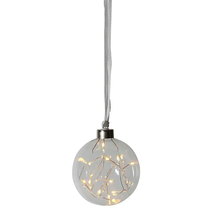 Eglo Lámpara colgante LED redonda Glow - 0,18 W, Diámetro: 10 cm, Blanco cálido, Gris - Primer plano de una bola de Navidad de cristal transparente con lazo plateado y luces de hadas blanco cálido, creando un ambiente festivo.