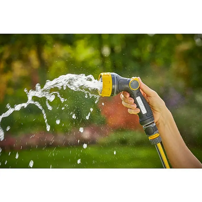 Neptun Bewässerungsbrause - Anzahl Sprühformen: 7 Stk. - Hand hält einen gelb-grauen Nisteln-Gartenschlauch, der Wasser sprüht, ideal zum Bewässern von Pflanzen und Gärten.