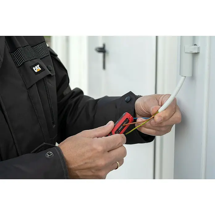 UniTEC Kabelentmanteler - Geeignet für Leitungsquerschnitt: 0,5 mm² - 6 mm² - Eine Person mit einer CAT-Jacke, die ein rotes Abisolierwerkzeug zum Abisolieren von Kabeln verwendet.