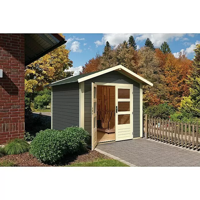 Karibu Gartenhaus Talkau 4 - Außenmaß inkl. Dachüberstand (B x T): 270 x 274 cm, Holz, Grau - Ein dunkelgrauer Holz-Gartenschuppen mit hellem Rahmen und grünem Dach, Türen offenbaren Gartengeräte, in einem herbstlichen Garten.